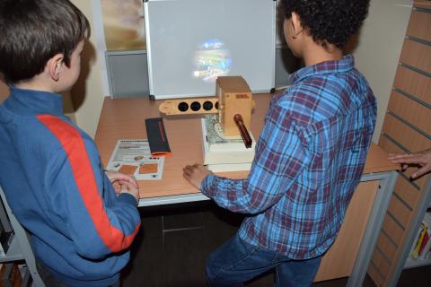2 enfants de dos regardant une image sur écran