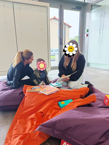 Deux femmes aident leur petit garçon à utiliser le Bookinou