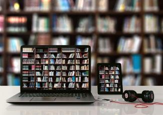 ordinateur et tablette présentant une photo de bibliothèque devant une bibliothèque